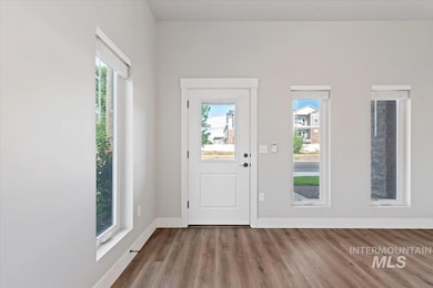 Foyer with plenty of natural light and wood finished floors