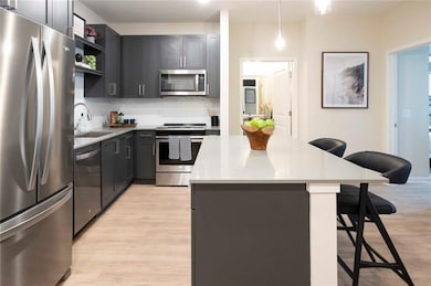 Kitchen featuring a breakfast bar area, light wood
