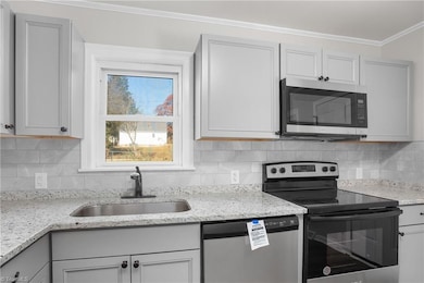 Kitchen - completely new!  New cabinets, new appliances new flooring.  Completely rewired and replumbed