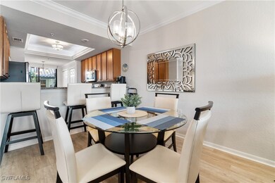 Dining room with a chandelier, a tray ceiling, lig