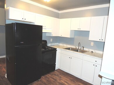 Kitchen with a sink, black appliances, under cabin