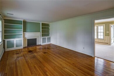 Formal living room has hw floors, crown molding, f