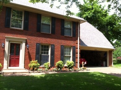 SITTING STATELY ON A COVE LOT, BRICK HOME WITH 2 C