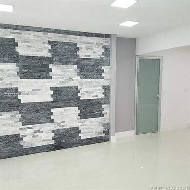 Foyer entrance with rock wall accent. Door leads t
