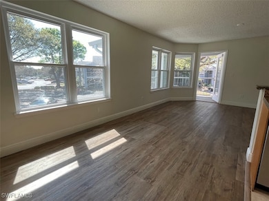 Unfurnished living room with a textured ceiling, b