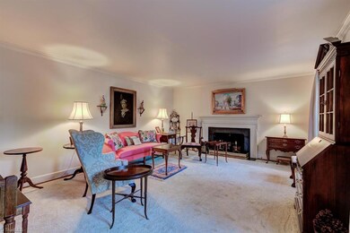 The first of three fireplaces is in this very spacious living room.