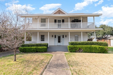 View of front of house featuring covered porch and a front yard