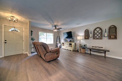 The entryway has a modern light fixture, and large