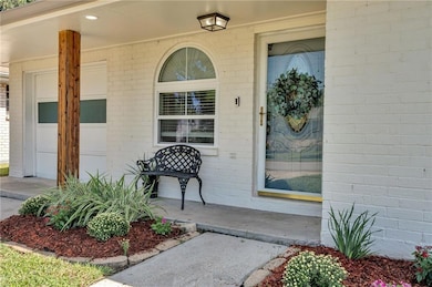 Inviting front entrance with shaded porch and fresh landscaping.