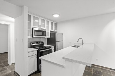 The kitchen has a full sized oven, microwave and refrigerator and garbage disposal.