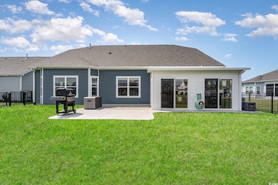 Rear view of property featuring fence, a patio, a 
