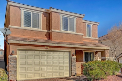 View of front facade featuring stone siding, an at