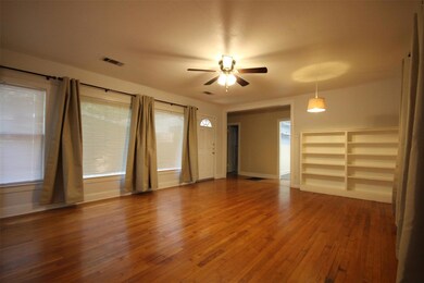 Unfurnished living room featuring hardwood / wood