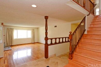 Dramatic staircase and view of formal living room