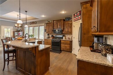 Beautiful Kitchen!  Granite Countertops, Breakfast Bar/Island, Gorgeous Cabinets, Pantry & newer Black Stainless Appliances!