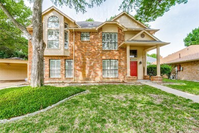View of front of property featuring a front lawn and a garage