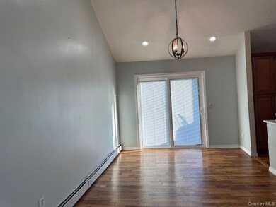 Unfurnished dining area featuring Wood Flooring dark wood-style floors, a chandelier, and recessed lighting