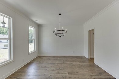 Unfurnished dining area with ornamental molding, w