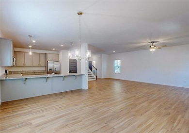 Kitchen with decorative light fixtures, appliances