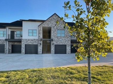 Contemporary house featuring a front yard, a garag