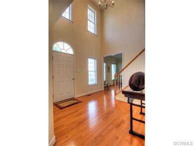 Soaring two story entry with gleaming hardwood flo
