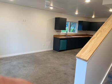 Kitchen with ceiling fan, dishwasher, concrete flo