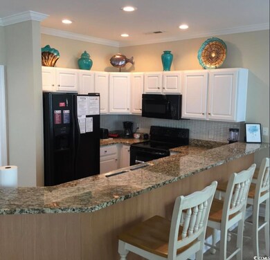 Kitchen featuring stone counters, decorative backs