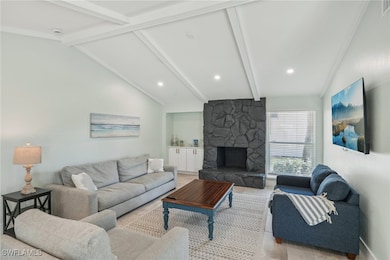 Living room featuring a fireplace, recessed lighti