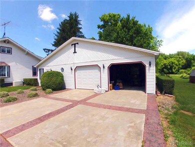 Exterior Front 3 Car Garage with Sun Room on left 