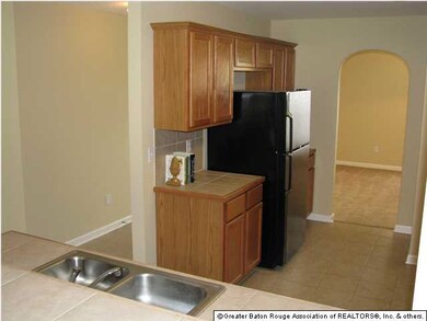 Ceramic tile on counters and floors in kitchen whi