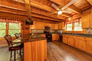 Beautiful kitchen with granite countertops, stone backsplash, updated appliances and new flooring!