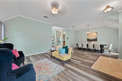 Living area with wood finished floors, vaulted ce
