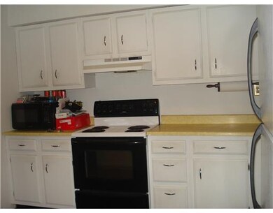 Kitchen. Kitchen has hardwood flooring.