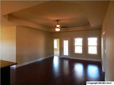 View from foyer to Great Room - Master BR is at farthest left and rear door leads to covered patio. Lots of hardwood too - all through the main living areas!