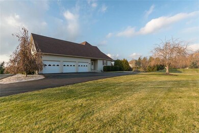 Another view of the 3 car garage and side yard