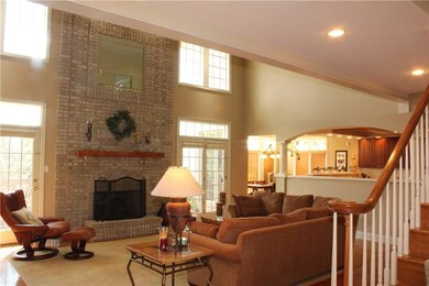 Great room fireplace is graced by two atrium doors