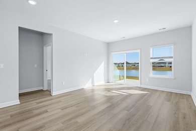Spare room featuring light hardwood / wood-style f