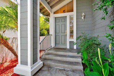 Welcome Home.  Covered porch and lush greenery.