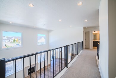 Hall with recessed lighting and light colored carpet