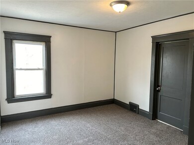 Spare room with carpet flooring and a textured ceiling