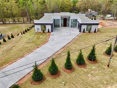 View of front of home driveway, a front yard.