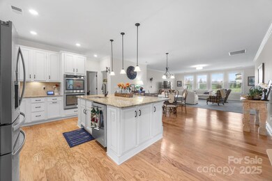 Open-concept design seamlessly links the kitchen, dining area, and great room