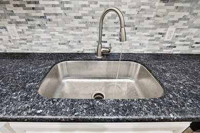 Showing off the upgraded granite and mosaic tile b