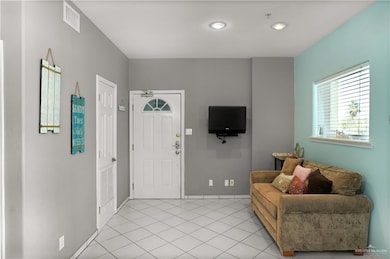 Entrance foyer with light tile patterned floors, baseboards, and visible vents