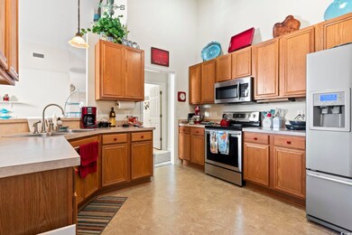 Kitchen featuring sink, a towering ceiling, decora