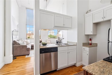 AI rendering of kitchen cabinets painted white & add'l storage