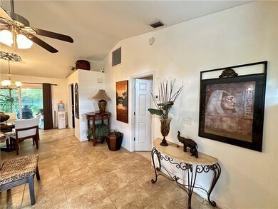 Hall featuring vaulted ceiling and a notable chand
