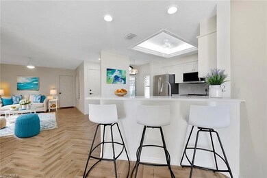 Kitchen featuring white cabinetry, kitchen peninsu
