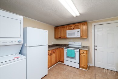 Kitchen with stacked washer dryer