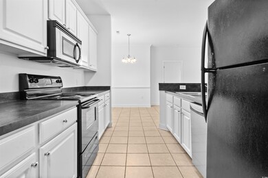 Kitchen with a notable chandelier, light tile patt